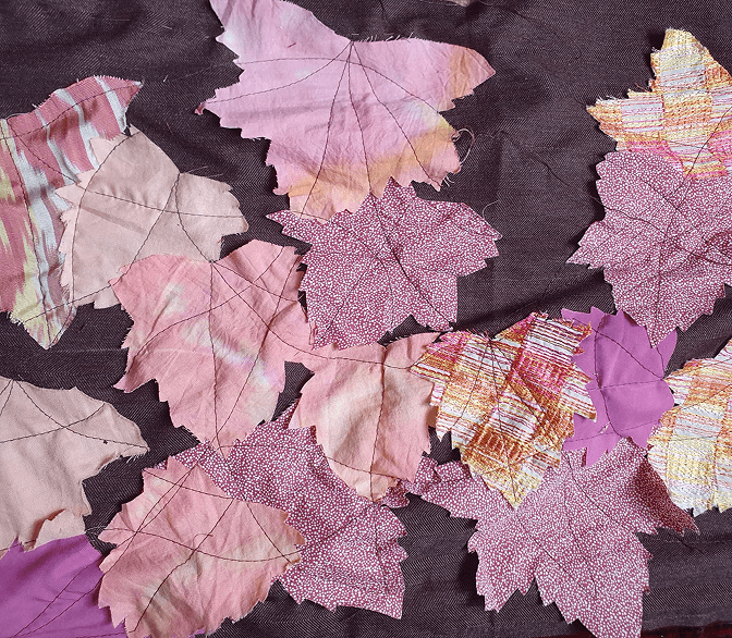 Layered handmade leaves in soft pink and berry textiles